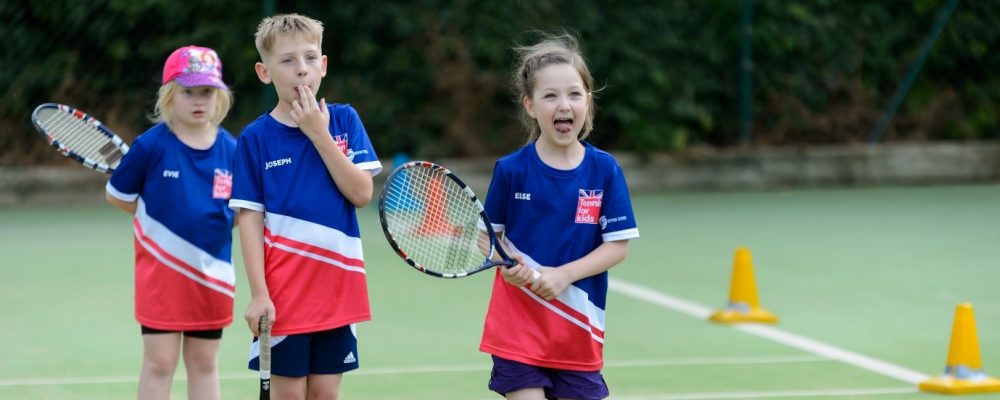 Child playing tennis