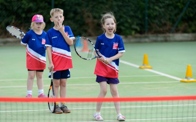 Child playing tennis