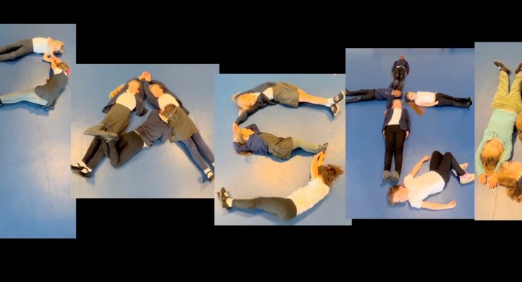 Children lying on the floor to form the letters that spell the word paste